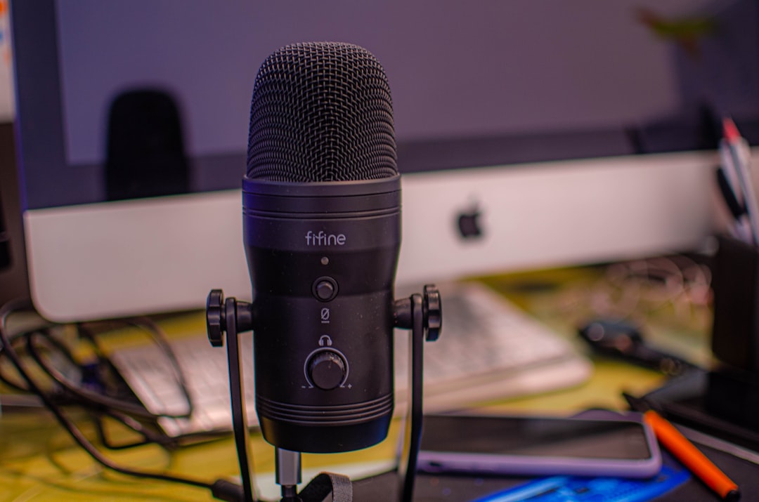 A podcast recording setup with microphones and a laptop showing a transcript-based edit